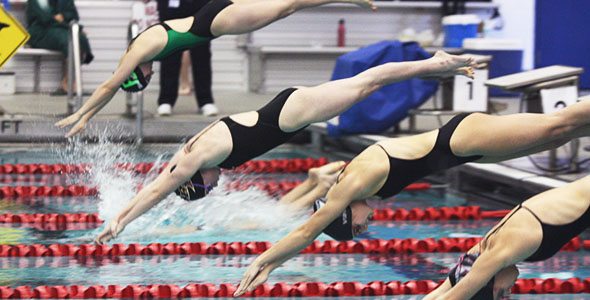 13 swimmers place at district, advance to regionals