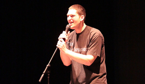 Senior Austin Thompson sings onstage at the Mr. Maroon talent show.