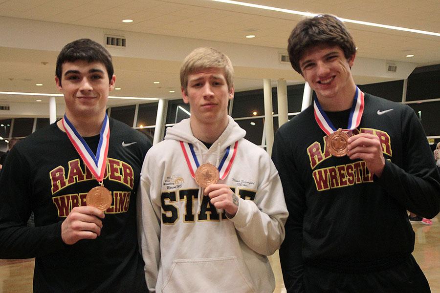 Seniors+Jesse+ORourke%2C+Micah+Schonfeld+and+Evan+Coleman+show+their+medals+from+the+4A+state+wrestling+meet.+