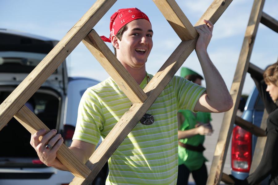 Chase Massey helps set up the theatre booth