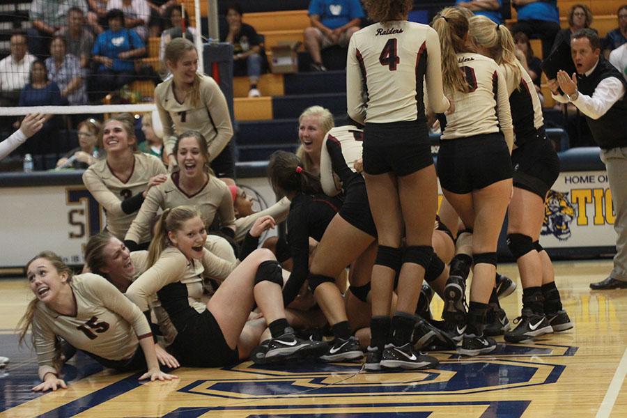 The+varsity+volleyball+team+celebrates+after+beating+Stony+Point+in+their+final+district+match.+The+volleyball+team+is+advancing+to+playoffs+for+the+first+time+in+school+history.