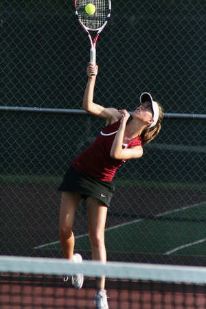 Brooke McKinnon serves during the Round Rock district match. McKinnon's match was the deciding on against Pflugerville that helped the Raiders qualify for area.