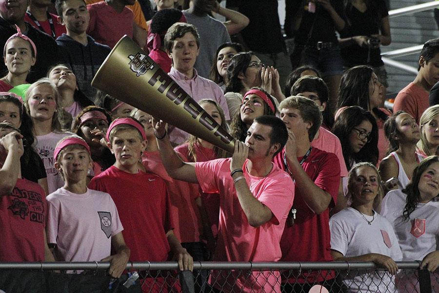 Senior Jacob Alger shouts to the team though a megaphone during the McNeil game.