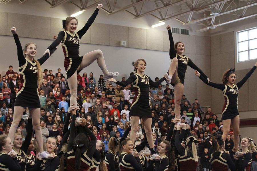 Cheerleaders perform a stunt for the pep rally.