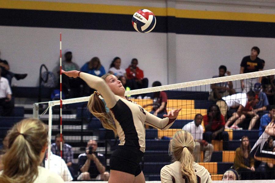 Freshman Ava Bell goes up for the kill at the Stony Point match. Bell was one of three freshmen on the varsity team.