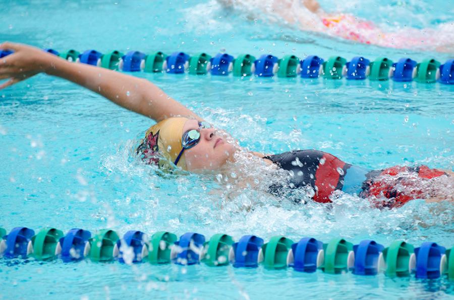 Natalie Saul swims backstroke at the Blockhouse swim meet against Meridian and Leander High School, Sept. 13.
