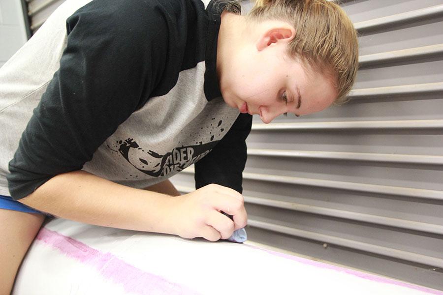 Senior Taylor Criswell works on a project for the fall show Big Love.