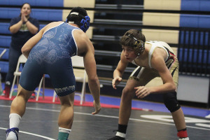 Freshman Tanner Looney squares off against his opponent in the 126 weight class at district.