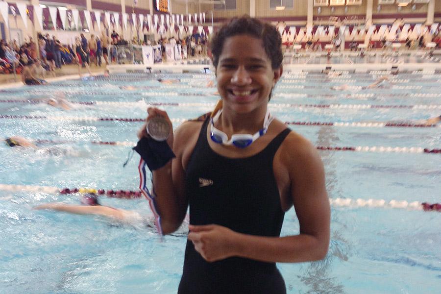 Junior Haley Timmons holds her silver medal at the regional meet Saturday, Feb. 7. Timmons took second in the 100 Fly.