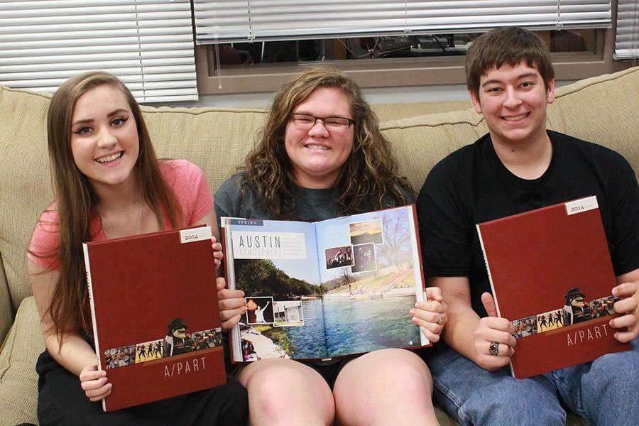 Editors Chandler Krause, Maddie Bonvillian and Anthony Pangonas hold the 2014 Replay. The yearbook was recently named a finalist for a Pacemaker by the National Scholastic Press Association.