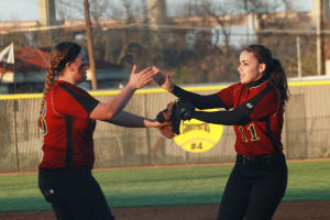 Pitcher Lexi Shafer is congratulated by teammate Gabriela Lopez-Ruperto after closing out another inning at the Westwood junior varsity game.