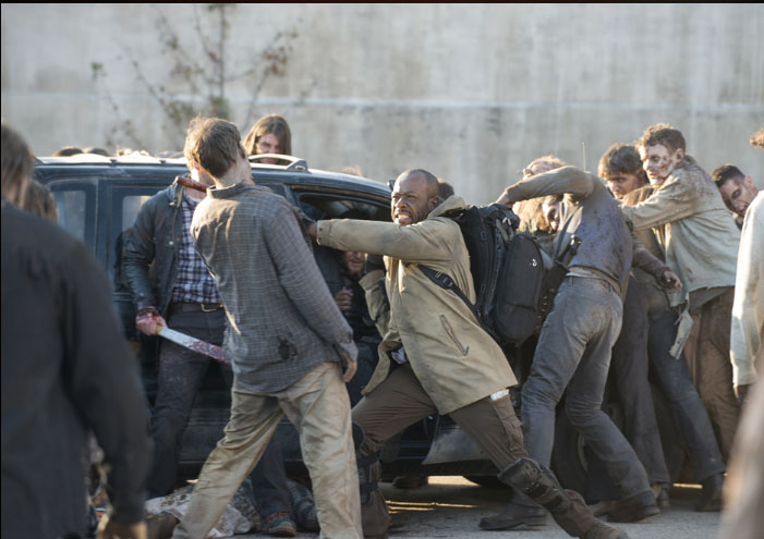 Morgan (Lennie James) fights off walkers to help Aaron and Daryl escape in the season five finale.
