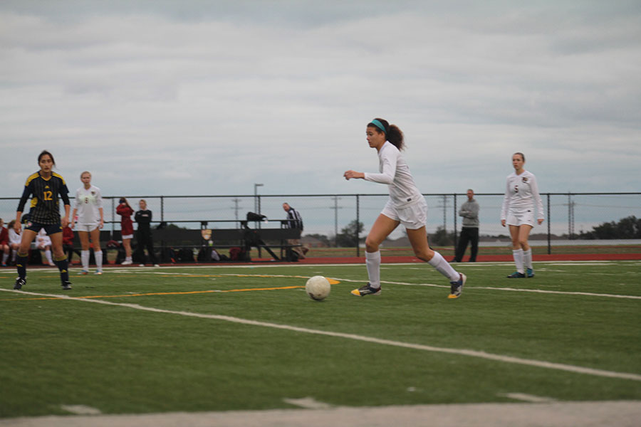 Sophomore Haley Hoppe runs the ball down the field in the Stony Point match.