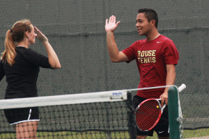 Ellie Mueller and Adrian Montes celebrate a point in their match against Westwood. Mueller and Montes lost the match, but won their final match to finish third in district in mixed doubles.