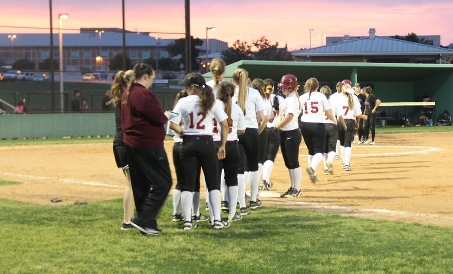 The softball team says the national anthem before their district game against Cedar Ridge