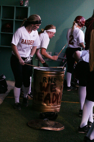 Kayleigh Norte and Hailley Falloon get pumped up by drumming on a painted tin trash can. 