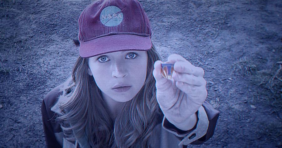 Whenever Casey Newton (Britt Robertson) touches a lapel pin with the letter T on it, she is transported to Tomorrowland.