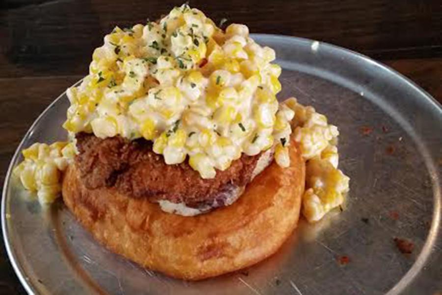 The Country Clucker comes with a fried chicken breast, a potato pancake and creamed corn, all on top of a doughnut.