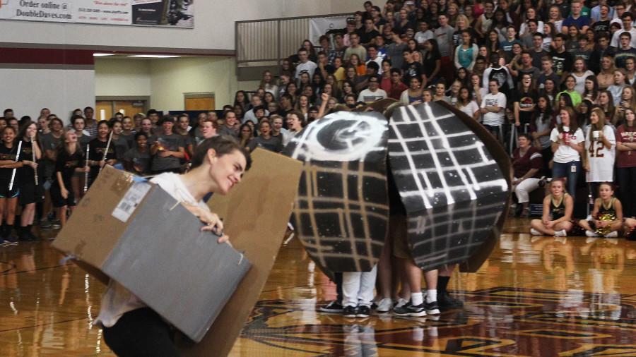 Brian Robison runs around the gym as an Imperial Tie fighter during the Leander pep rally. Robinson lost one side of his fighter during the skit, but kept in character.