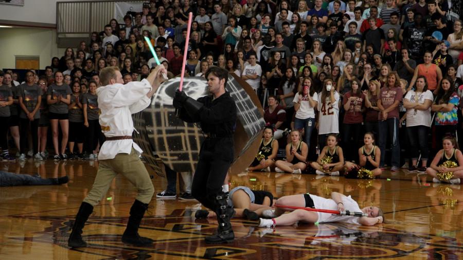 Chet Hamilton and Weston Bonnet wage a light saber fight during the Leander pep rally. Theatre always produces a skit each pep rally with Rouse taking on the opposing team.