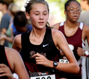 Freshman Emily Forster runs in the Cedar Park meet. Forster has been the top finisher for the varsity girls in three meets.