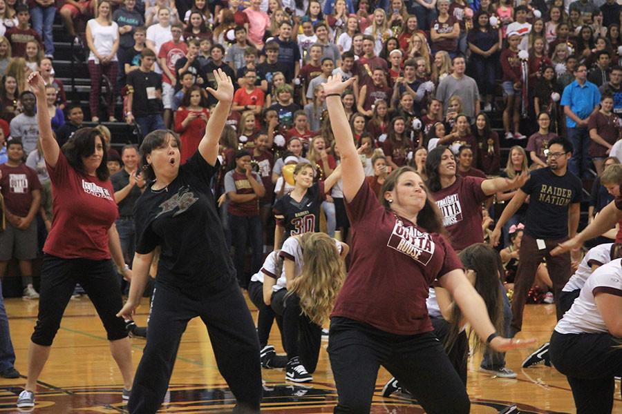 Stephanie Smith and Jennifer Bussear dance during the Homecoming pep rally.