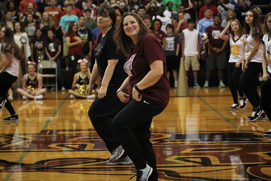 Teacher Jennifer Bussear dances with the faculty and Royals at the Homecoming pep rally.