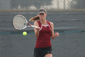 Brooke McKinnon returns the ball during the Hendrickson match. The Raiders won the district match 10-4 to advance to the semifinals.