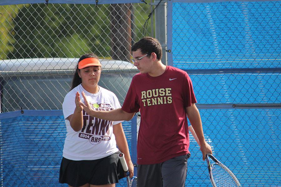 Senior Styliana Espinoza and sophomore Sam Wilhite celebrate a point in their Pflugerville match. The mixed doubles team clichéd a pivotal match in the first round to help the Raiders beat Hendrickson 10-4 and move on to face Pflugerville in the district semifinals.