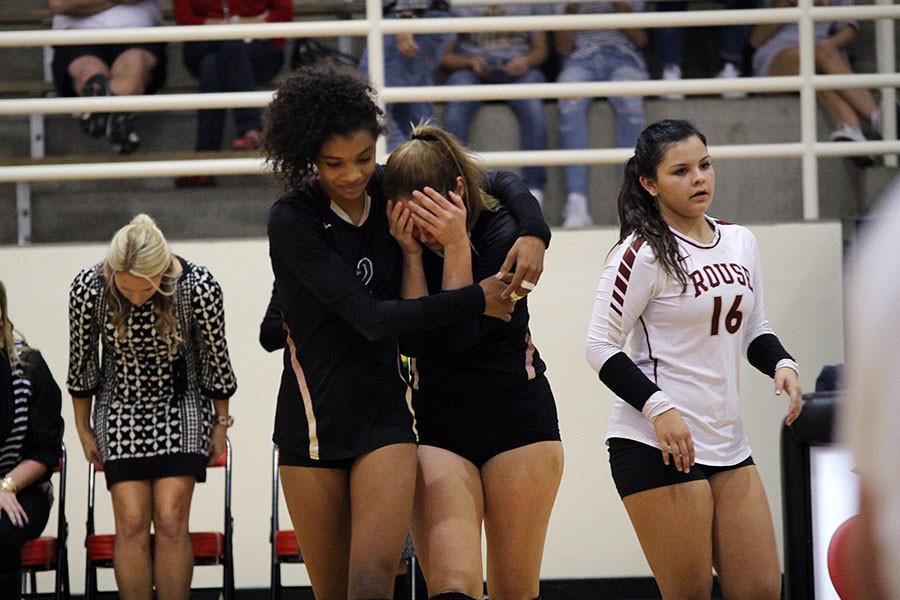 Teammate elan McCall comforts senior Sydney Harter after the teams four set loss to Lake Travis.