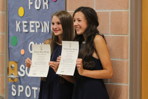 Juniors Ashton Hilsenteger and Madison Schultz hold up their NHS certificates for a picture after the ceremony.