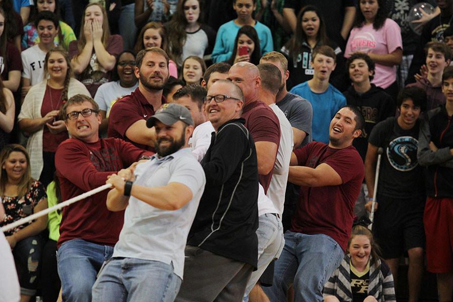 The football coaches participated in the tug of war.