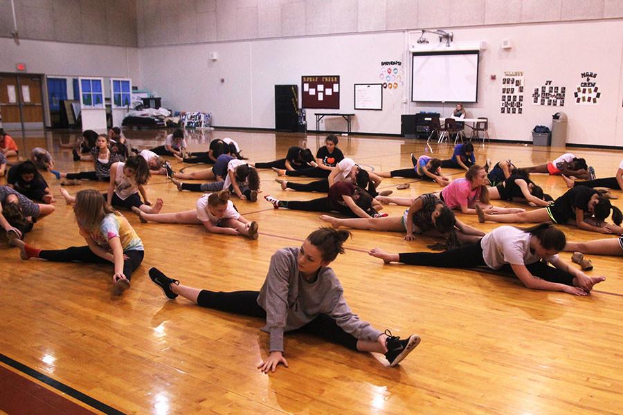 Dance Prep students stretch during 7th period. Auditions for the Royals and Rhythm Dance Company are Dec. 9 and the students find out Dec. 11 if they made one of the teams.