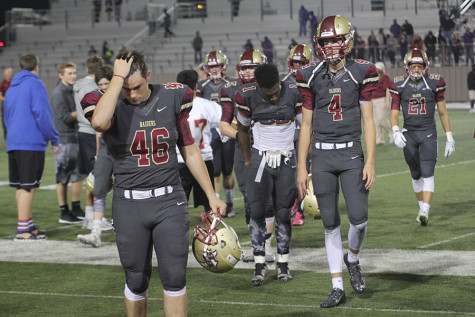 Juniors Cooper Ligon (46) and Michael Forster (4) walk off the field after Hendrickson loss and final game of the season. 