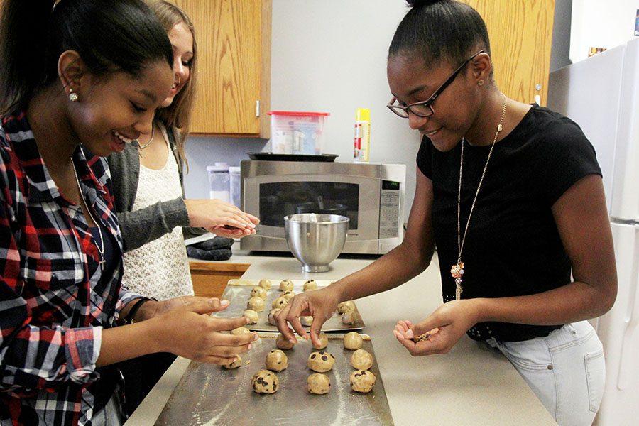 Rolling dough, senior Mayia Miles and juniors Loreen Wagner and Daszia Sullivan prepare chocolate chip cookies during Megan Wolskes Culinary Prep class fifth period. When baking cookies, my group and I had a blast and its safe to say our cookies were the bomb, Sullivan said. Honestly, my favorite part about Culinary is getting to eat.