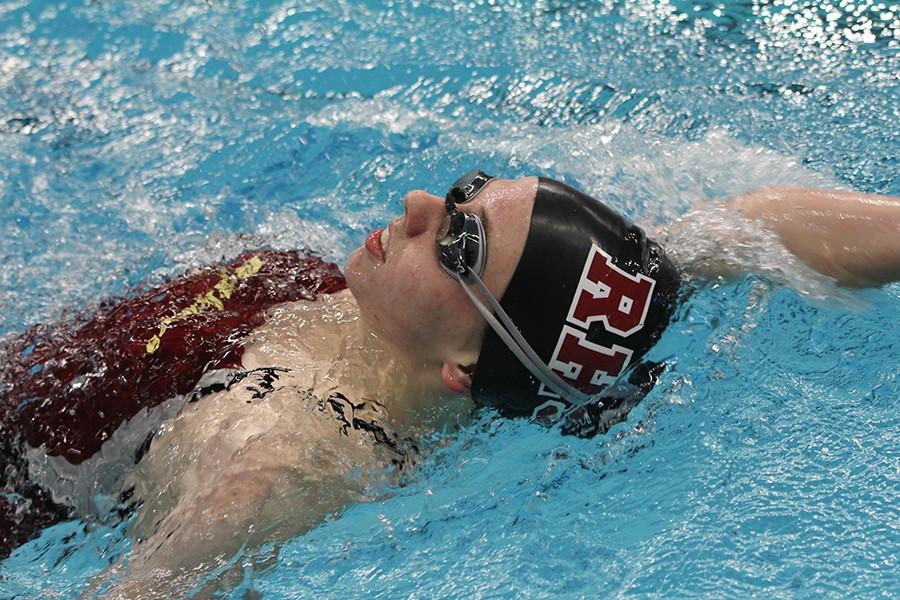 Cassie Cox competes in the backstroke at the AISD Invitational meet.