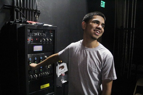 Junior Dominic Ureste adjusts the level of the lighting during fifth period.