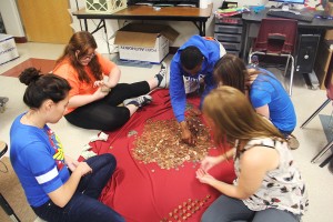 Student Council members count the change from the Pennies for Patients battle during third period.
