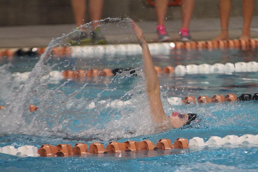 Jaide Castle swims the final length of the 100 backstroke in the finals at district. Castle finished third in 1:01.48.