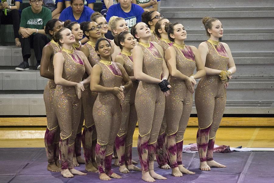The+varsity+winter+guard+team+performs+at+the+TCGC+competition+at+Cedar+Park%2C+Feb.+20.