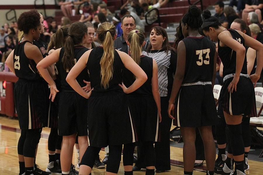 Coach Lori McDonald advises her team during the Round Rock game. McDonald has been the girls basketball head coach since the school opened in 2008.