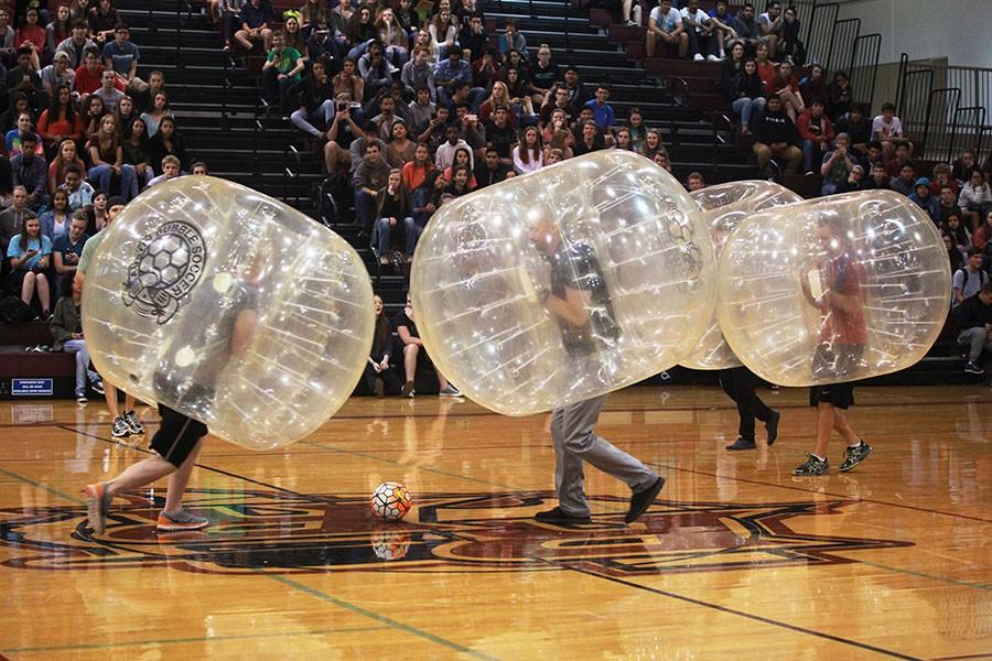 Geometry and Algebra teacher Joel Morton and Pleasant Hill Elementary Principal Mark Koller go after the ball in the faculty versus administration bubble soccer game.  “It was way more exhausting and a lot more work than I thought it was going to be,” Morton said.