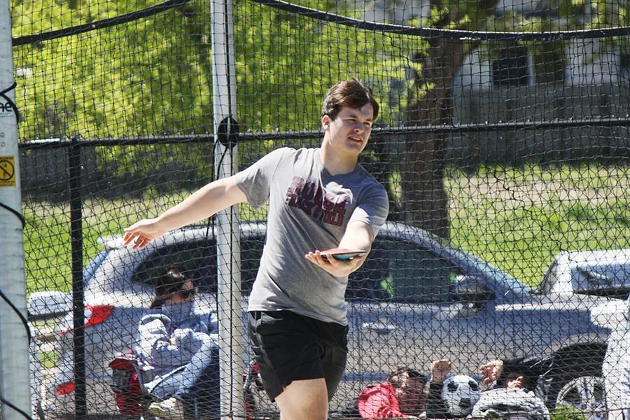 Junior Adam May competes in the discus at the Leander meet.
