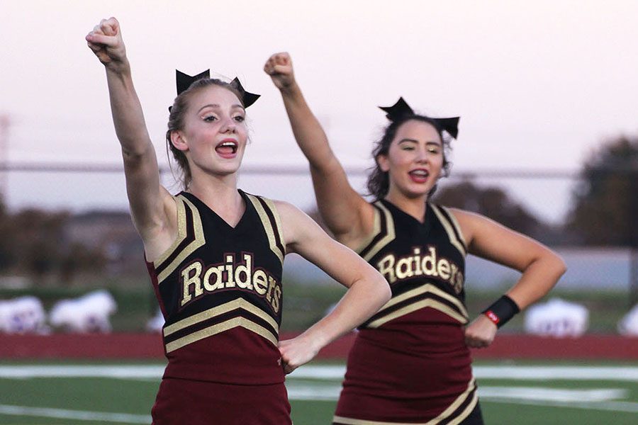 On the sidelines, freshmen Mara Everson and Sydney Cooper cheer at the junior varsity 1 Pflugerville game. It was a really hyped game and they did good, Cooper said. I loved the students we did and having fun with the music they played.