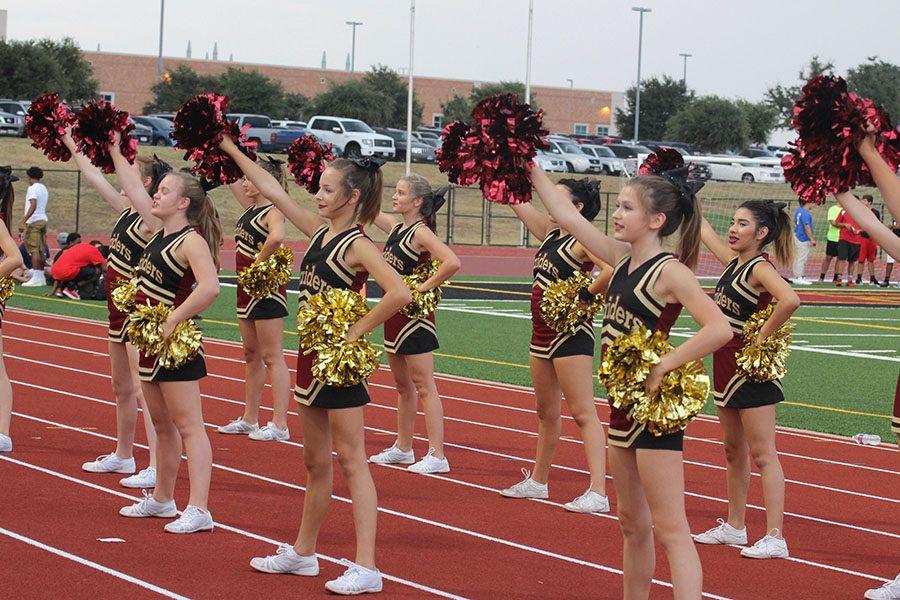 The junior varsity team cheers at the JV1 Leander game.