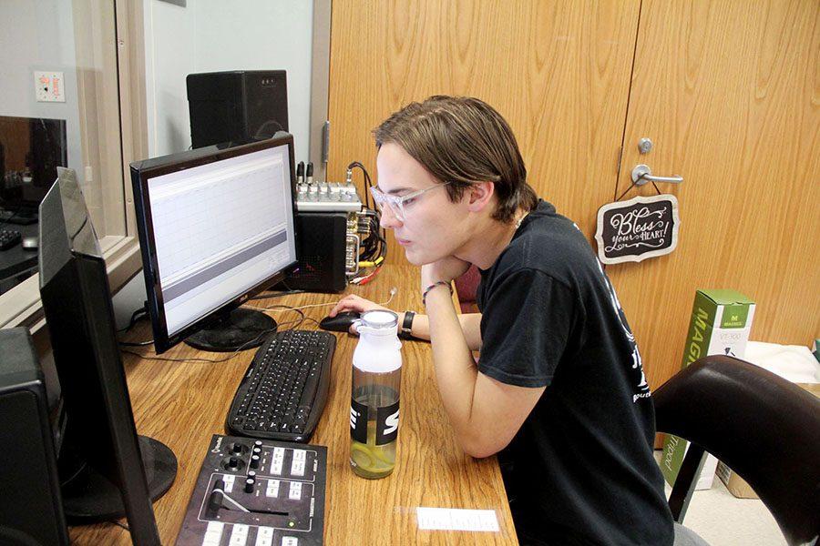 Senior Kyle Pace works at the control booth during filming.