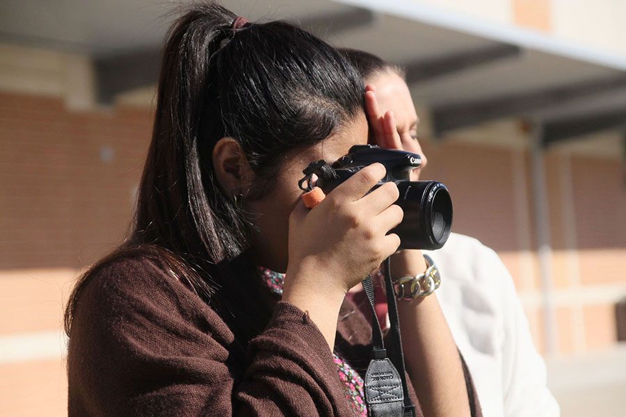 Sophomore Jenavie Orta takes a picture for a class assignment in Photojournalism. Orta, who was part of the Air Force ROTC program at Leander, attended Rouse on A days and LHS on B days.
