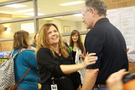 Assistant principal Bob Syner (right) congratulates Christine Simpson on receiving the principal job at Rouse.