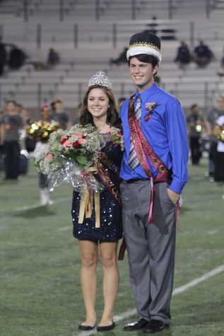 After learning they were elected by the student body as 2015 homecoming King and Queen, graduates Dustin Asbury and Sydney Lamanski take a photo together on the football field.