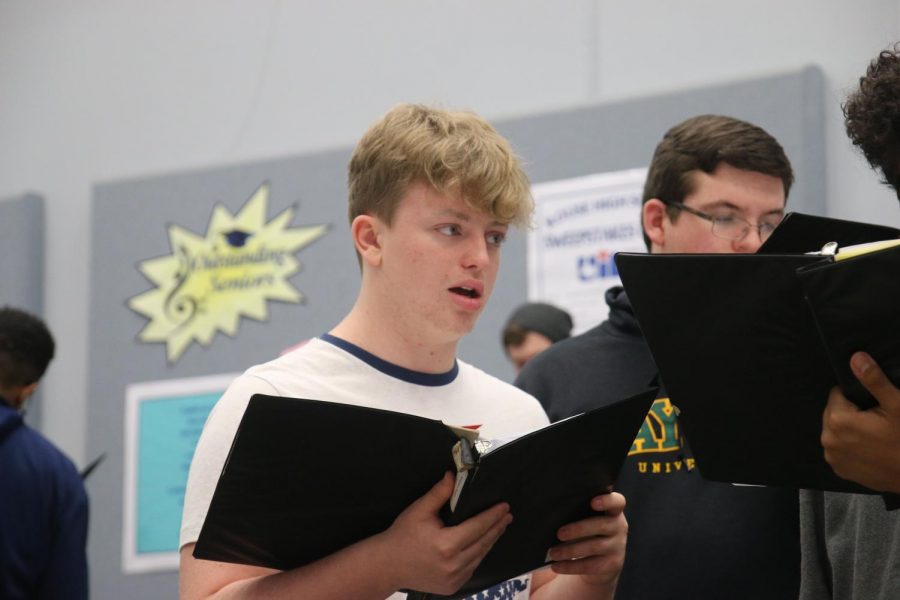 Senior Keaton Pugh rehearses his choir music under the direction of choir director Brenda Justice.